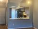 An open view of the kitchen with black appliances and light countertops from the living area at 4709 Almond Willow Dr, Orlando, FL 32808