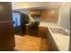 Well-lit kitchen features black appliances, light countertops, and wood flooring at 4709 Almond Willow Dr, Orlando, FL 32808