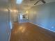 Open-concept living room featuring hardwood floors, vaulted ceiling, and lots of natural light at 4709 Almond Willow Dr, Orlando, FL 32808