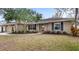 Single-story house with stone exterior, two-car garage, and manicured lawn at 4865 Fayann St, Orlando, FL 32812