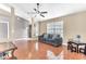 Living room featuring tile floors, a gray couch, and a ceiling fan at 5142 Wood Ridge Ct, Ocoee, FL 34761