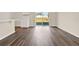 Bright living room with vinyl wood flooring and sliding glass doors to backyard at 5531 Hayloft Dr, Apopka, FL 32712
