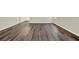 Living room with dark brown vinyl flooring and neutral wall colors at 5531 Hayloft Dr, Apopka, FL 32712