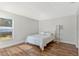 Cozy bedroom featuring wood floors, natural light from a large window, and neutral decor at 5726 Essex Isle Dr, Orlando, FL 32829