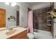 Bathroom features a tub, shower and updated tile at 5800 N Dean Rd, Orlando, FL 32817