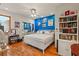 Bright bedroom with a king-size bed and blue accent wall at 5800 N Dean Rd, Orlando, FL 32817
