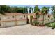 Large, two-story home with an oversized garage and brick paved driveway, surrounded by mature palm trees at 5800 N Dean Rd, Orlando, FL 32817