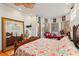 Luxurious main bedroom featuring a large mirror and sitting area at 5800 N Dean Rd, Orlando, FL 32817