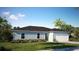 Single-story home with a two-car garage and landscaped lawn at 590 E Division W St, Deland, FL 32724