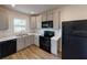 Modern kitchen with gray cabinets and black appliances at 590 E Division W St, Deland, FL 32724