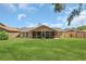Wide view of backyard showcasing large grassy area, screened porch and privacy fence at 605 Marni Dr, Winter Springs, FL 32708