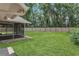 Expansive backyard showing a screened-in lanai and a wooden fence providing privacy at 605 Marni Dr, Winter Springs, FL 32708