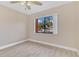A bedroom with hardwood floors, tan walls, ceiling fan, and a large window at 605 Marni Dr, Winter Springs, FL 32708