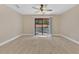 Bedroom with tile flooring, ceiling fan, and sliding glass door to the backyard at 605 Marni Dr, Winter Springs, FL 32708
