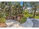 Outdoor grilling area with a brick barbecue, picnic tables, and serene surroundings at 605 Marni Dr, Winter Springs, FL 32708