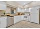 Bright kitchen with white cabinets, stainless steel appliances, and granite countertops at 605 Marni Dr, Winter Springs, FL 32708