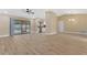 Open-concept living room with new tile floors, abundant natural light, and access to the screened lanai at 605 Marni Dr, Winter Springs, FL 32708