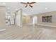 Bright living room with new flooring, ceiling fan, and adjacent kitchen and dining areas at 605 Marni Dr, Winter Springs, FL 32708