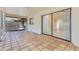 Covered patio with terracotta tile, screened walls, and view of the house interior at 605 Marni Dr, Winter Springs, FL 32708
