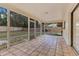 Covered patio with terracotta tile, screened walls, and view of the backyard at 605 Marni Dr, Winter Springs, FL 32708