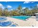 Community pool area with lounge chairs and beautiful landscaping, perfect for relaxation and recreation at 605 Marni Dr, Winter Springs, FL 32708