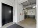 Hallway view showcasing an elevator, bulletin board, and cabinet storage at 62 W Colonial Dr # 302, Orlando, FL 32801
