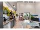 Stylish living room featuring exposed brick, lots of plants and an open kitchen at 62 W Colonial Dr # 302, Orlando, FL 32801