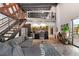 Open-concept living space with stairs, kitchen, and a comfortable sectional sofa at 62 W Colonial Dr # 302, Orlando, FL 32801