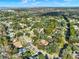 High angle aerial view of a neighborhood and its proximity to a large body of water at 694 Benitawood Ct, Winter Springs, FL 32708