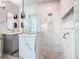 Modern bathroom with a glass-enclosed shower, sleek vanity, and marble tile at 8130 Yellow Crane Dr, Kissimmee, FL 34747