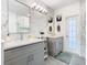 Well-lit bathroom with double sinks, modern fixtures, and marble accents at 8130 Yellow Crane Dr, Kissimmee, FL 34747