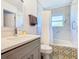 Bright bathroom with marble tile, patterned tub trim, and updated vanity at 8130 Yellow Crane Dr, Kissimmee, FL 34747