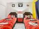 ' bedroom with Mickey Mouse themed decor, twin beds and playful accents at 8130 Yellow Crane Dr, Kissimmee, FL 34747