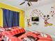 ' bedroom with Mickey Mouse themed decor, twin beds and playful accents at 8130 Yellow Crane Dr, Kissimmee, FL 34747