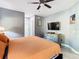 Cozy bedroom featuring a ceiling fan and dresser with decor at 8130 Yellow Crane Dr, Kissimmee, FL 34747