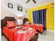 ' bedroom with Mickey Mouse themed decor, twin beds and playful accents at 8130 Yellow Crane Dr, Kissimmee, FL 34747