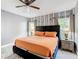 Inviting bedroom with a large bed, side tables, and plenty of natural light at 8130 Yellow Crane Dr, Kissimmee, FL 34747