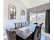 Elegant dining room featuring a modern chandelier, large table and seating for eight at 8130 Yellow Crane Dr, Kissimmee, FL 34747