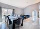 Open-concept dining and living room with high ceilings, stylish furniture, and large windows at 8130 Yellow Crane Dr, Kissimmee, FL 34747