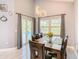 A light filled dining room with a view of the pool through sliding glass doors at 8130 Yellow Crane Dr, Kissimmee, FL 34747