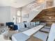 Modern dining room with a wood accent wall, unique chandelier and staircase at 8130 Yellow Crane Dr, Kissimmee, FL 34747