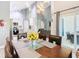 A dining room with a modern light fixture and a view into the living room and kitchen at 8130 Yellow Crane Dr, Kissimmee, FL 34747