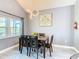 A modern dining room with stylish light fixture and seating for four at 8130 Yellow Crane Dr, Kissimmee, FL 34747