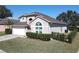 Well-maintained two-story home with a lush green lawn and a two-car garage at 8130 Yellow Crane Dr, Kissimmee, FL 34747