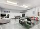 Large game room with pool table, foosball, and gaming area for entertainment at 8130 Yellow Crane Dr, Kissimmee, FL 34747