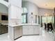 Bright, open kitchen design featuring modern appliances, white cabinets, and island sink at 8130 Yellow Crane Dr, Kissimmee, FL 34747