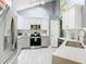 A bright, modern kitchen with stainless steel appliances and white cabinets at 8130 Yellow Crane Dr, Kissimmee, FL 34747