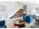 Open-concept living space featuring staircase, modern decor, and sleek tile flooring at 8130 Yellow Crane Dr, Kissimmee, FL 34747