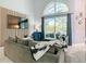 Bright living room with vaulted ceilings, large window, and stylish decor at 8130 Yellow Crane Dr, Kissimmee, FL 34747