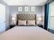 This bedroom features a statement headboard, matching nightstands, and stylish wall art at 8130 Yellow Crane Dr, Kissimmee, FL 34747